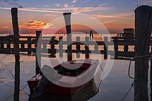 Sunset view of the Venetian lagoon with moored boat, Pellestrina island, Venetian lagoon, Italy