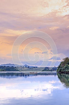 Sunset view of the Victoria Nile river, with trees growing and the reflections on the water, Jinja, Uganda