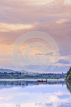 Sunset view of the Victoria Nile river, with trees growing and the reflections on the water, Jinja, Uganda