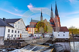 Sunset view of white building of Uppland museum and cathedral in Uppsala, Sweden