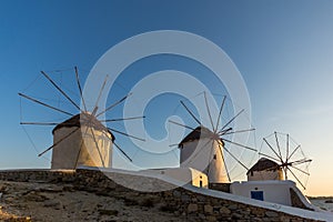 Sunset view of White windmills on the island of Mykonos, Greece