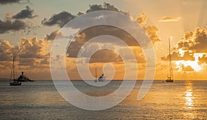 Sunset view of yachts anchored in the lagoon, Britannia bay, Mustique island, Saint Vincent and the Grenadines, Caribbean sea