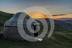 Sunset view of a yurt in mountains near Song Kul lake, Kyrgyzst