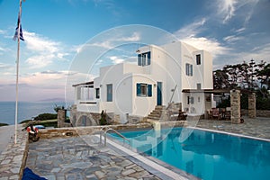 Sunset vila and pool view during hot summer day on Antiparos island in Cyclades in Greece