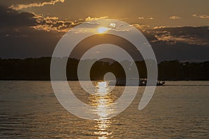 Sunset on the Volga River. In the distance there are mountains Zhiguli. The golden path is reflected in the water.