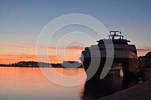 Sunset with waiting boat to deliver passangers photo