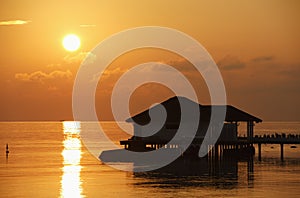 Sunset with water bungalow in the Indian Ocean, Ma