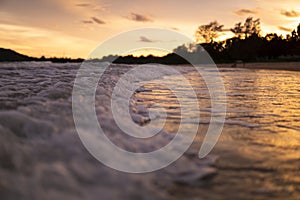 Sunset with wave on the beach at the Island as for summer