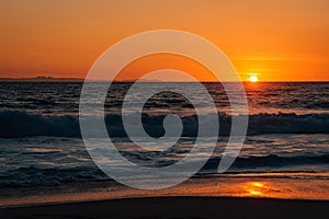 Sunset and waves in Pacific Ocean at Thousand Steps Beach, in Laguna Beach, Orange County, California