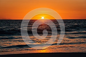 Sunset and waves in Pacific Ocean at Thousand Steps Beach, in Laguna Beach, Orange County, California