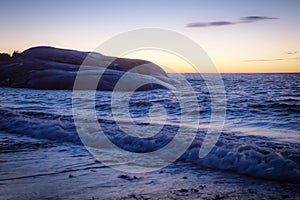 After sunset with waves on rocks