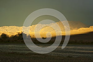 A sunset in western Mongolia with dark sky and a sunbeam.