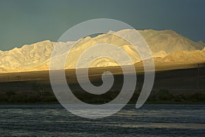 A sunset in western Mongolia with dark sky and a sunbeam.