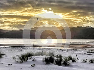 Sunset and white sand at Matarangi beach. Coromandel. New Zealand photo
