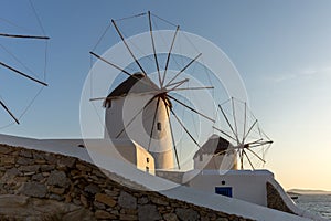 Sunset of White windmills and Aegean sea on the island of Mykonos, Greece