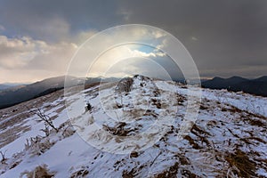 Sunset in winter mountains with dramatic light