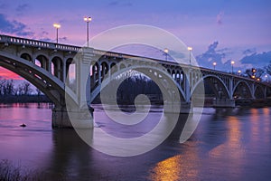 The sunsets behind the Lincoln Memorial Bridge spanning the Wabash River in Vincennes, Indiana