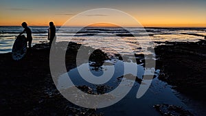 Sunsets and Surfers at Swamis Reef Surf Park Encinitas California.