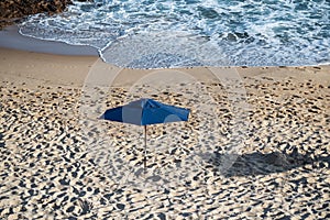 Sunshade on the beach in the strong sun of the day photo