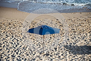 Sunshade on the beach in the strong sun of the day photo