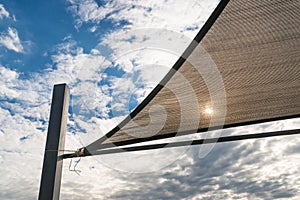 Sunshade in sails shape and blue sky background