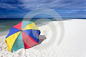 Sunshade on tropical white beach photo