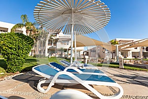 sunshade umbrellas and sunbeds near pool in Jaz Casa Del Mar Resort in Hurghada, Egypt