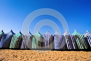 Sunshades in beach at summer against blue sky photo