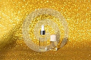 Sunshin glitter background. Skincare oil concept. Glass bottle