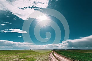 Sunshine Above Spring Rural Meadow Field And Country Open Road.