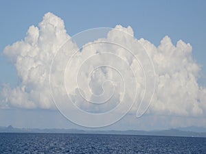 Sunshine blue sea and the sky with white clouds in the clear sky above the water surface.