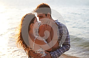 Sunshine, couple hug on beach and sea, travel for anniversary or date with bonding, love and support. Affection, peace