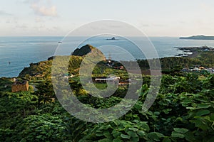 Sunshine on Dragon head hill reaching into ocean at Yongmeori Coast, Sanbang-ro, Jeju Island, South Korea