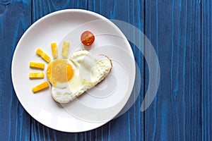 Sunshine fried eggs breakfast for kid on blue background