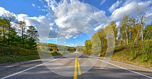 Sunshine road, single point perspective down a country highway in summer.