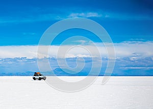 Sunshine scenery of Salar de Uyuni in Bolivia and jeep