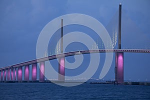 Sunshine Skyway Bridge in Tampa Bay Florida lit in pink lights to commemorate Breast Cancer Awareness Month photo