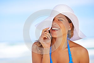 Sunshine and smiles. a beautiful young woman at the beach.