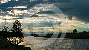 Sunshine through storm clouds over Madison River