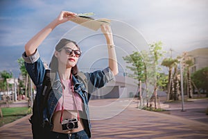 Sunshine in the summer and women traveler hold a map to protect