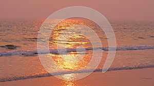 Sunshine from sunset at beach  scenery  on wet sand and incoming ocean waves