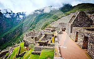Sunshine view of Machupicchu stone anchient walls and temple among mountains