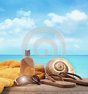 Suntan lotion and sandals at the beach