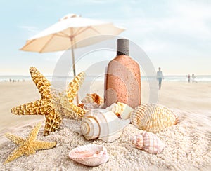 Suntan lotion and seashells on the beach photo