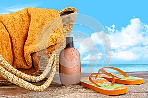 Suntan lotion, with towel at the beach
