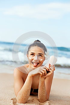 Suntan lotion woman applying sunscreen solar cream.