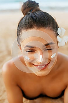 Suntan lotion woman applying sunscreen solar cream. Beautiful happy cute woman  applying suntan c