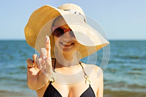 Suntan lotion woman applying sunscreen solar cream. Beautiful happy cute woman applying suntan cream. Sunscreen on the finger