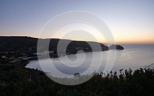 Sunup on calamosca beach from capo sant`Elia lighthouse photo