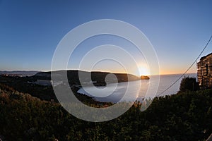 Sunup on calamosca beach from capo sant`Elia lighthouse photo